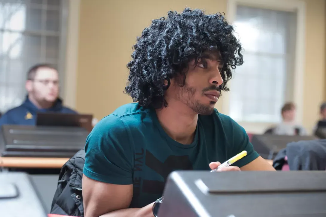 Business Management student in classroom at computer terminal