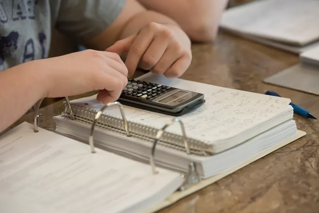 Close-up of student's notebook and calculator